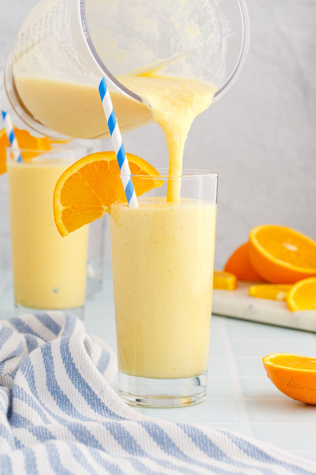 pouring an Orange Julius from a blender