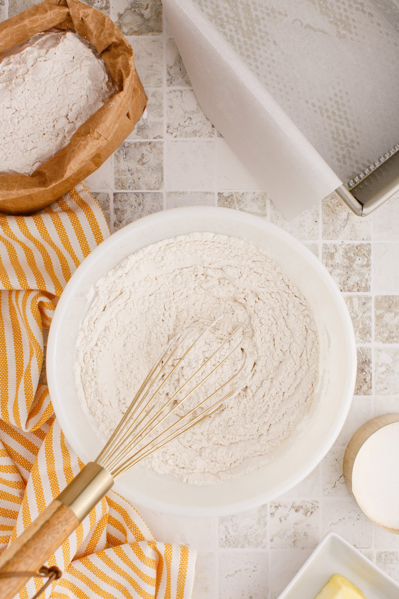 whisking the flour and dry ingredients for quick bread in a bowl
