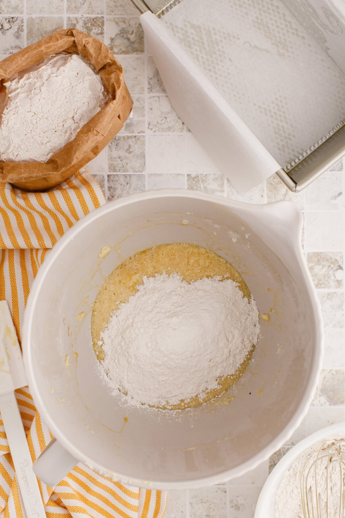 adding flour mixture to creamed butter, sugar, and eggs
