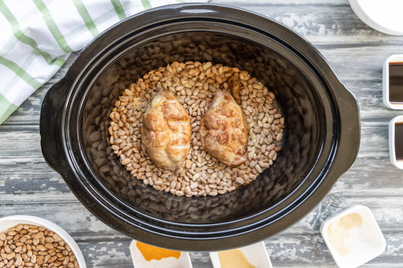 turkey tails on top of crockpot pinto beans