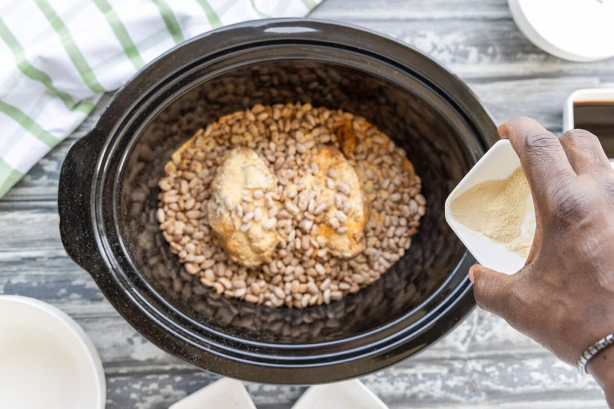 adding pinto beans on top of turkey tails with seasoning