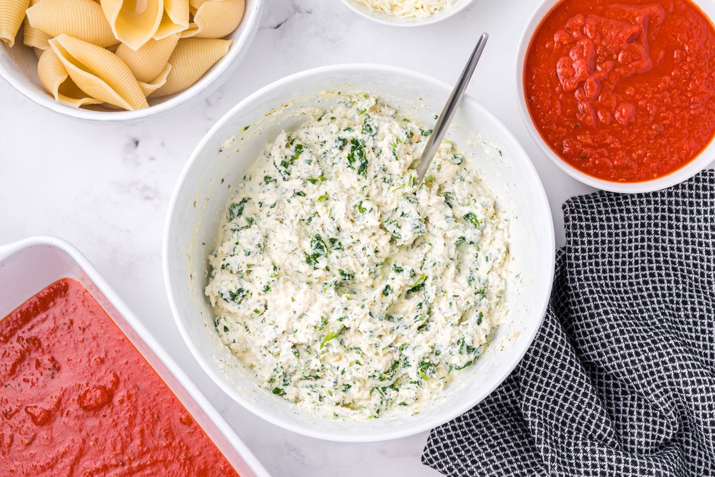 ricotta, parmesan, and spinach mixed in a bowl
