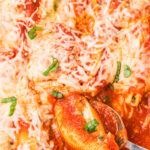 pan of Stuffed Shells with a spoon