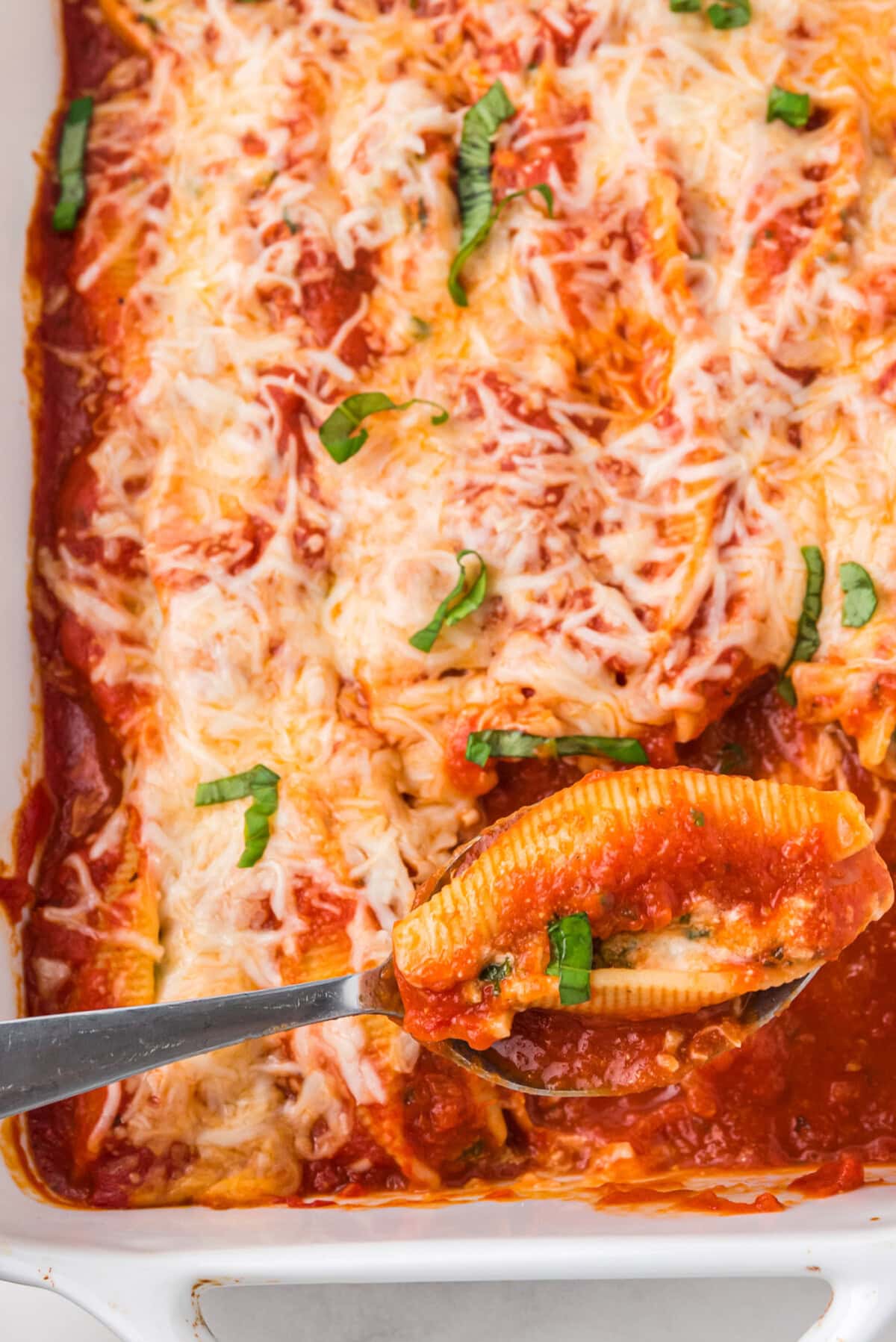 spoon in a pan of Stuffed Shells