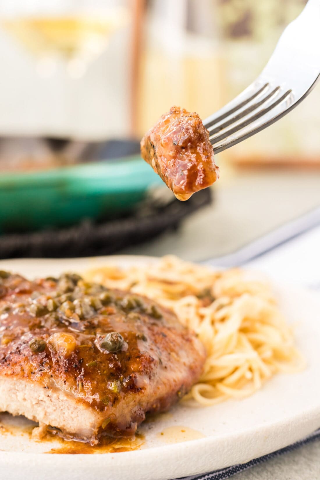 fork with a bite of Veal Piccata