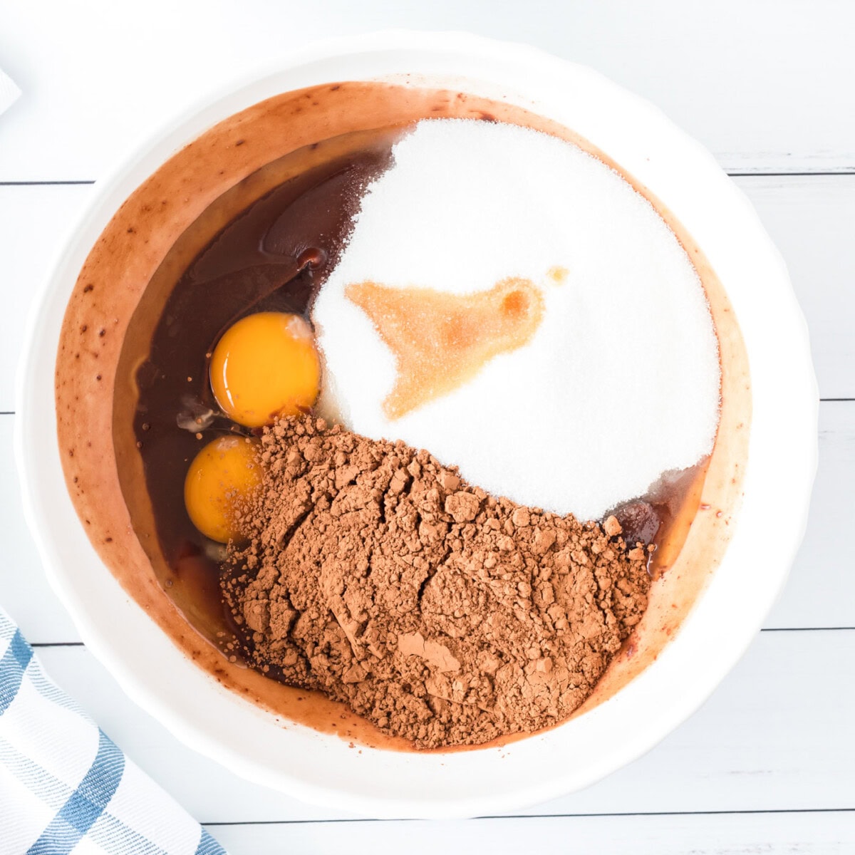 egg, cocoa, sugars, and vanilla in a bowl for making brownies