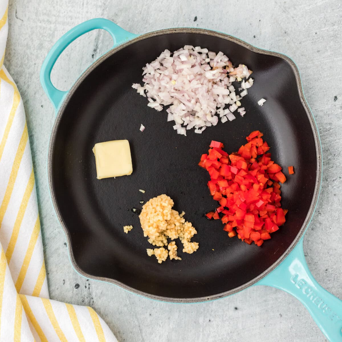 red bell pepper, shallots, and garlic with butter in a skillet