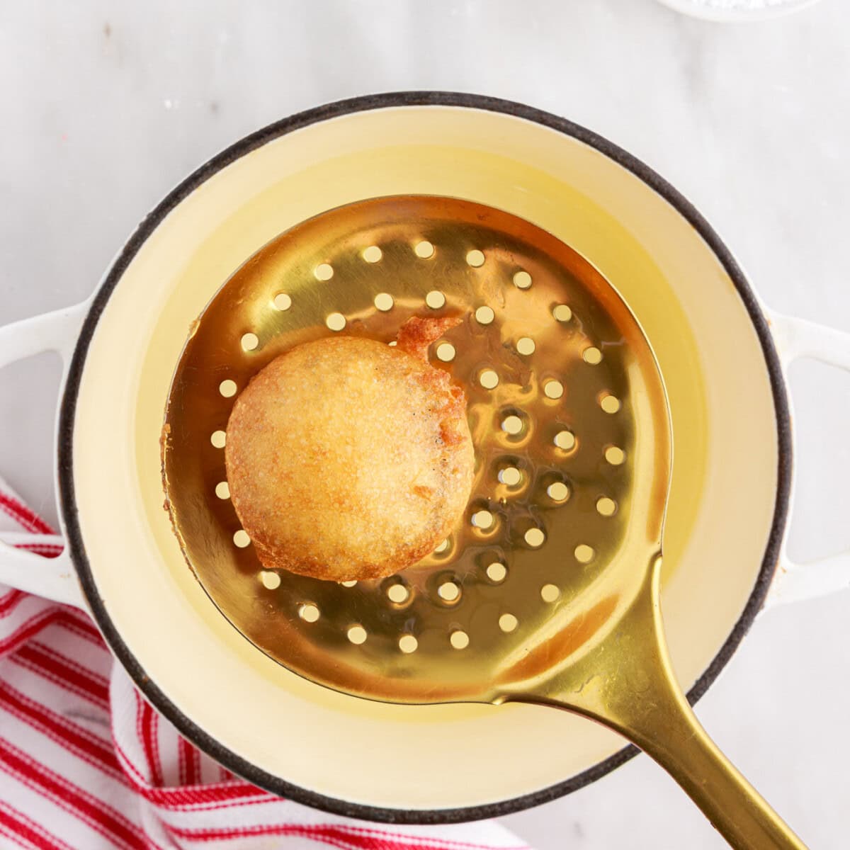 deep fried oreo on a slotted spoon
