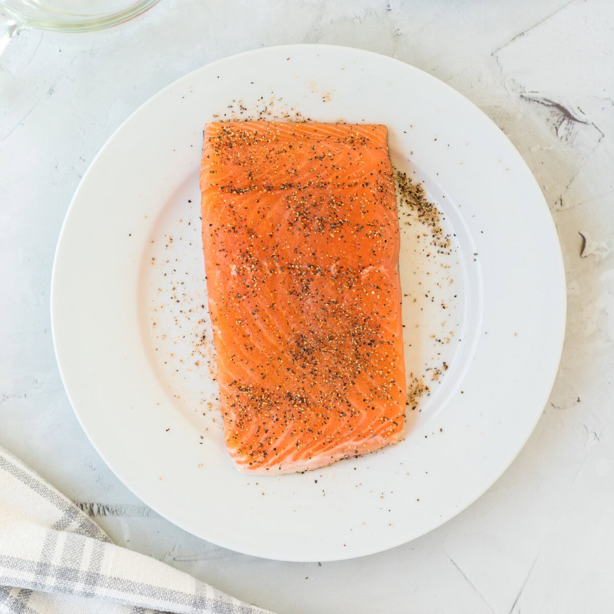 center cut salmon filet seasoned on a plate