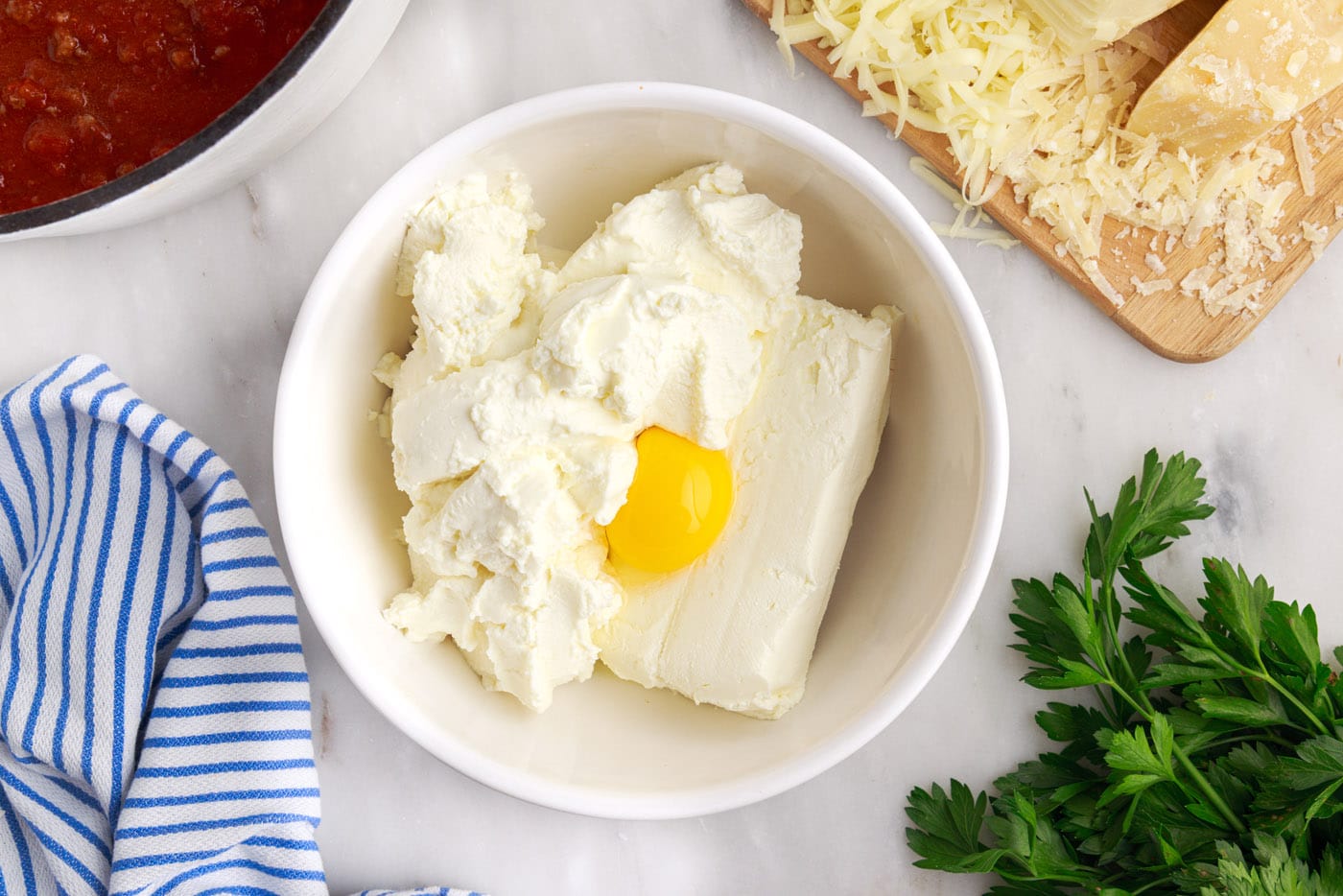 cream cheese, egg, and ricotta in a bowl