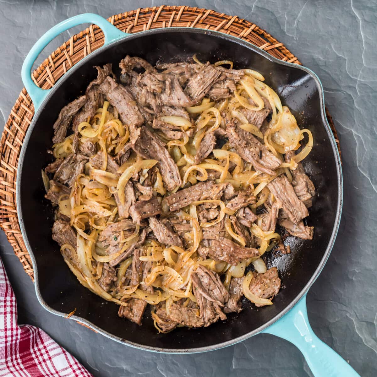philly cheesesteak ingredients in a skillet