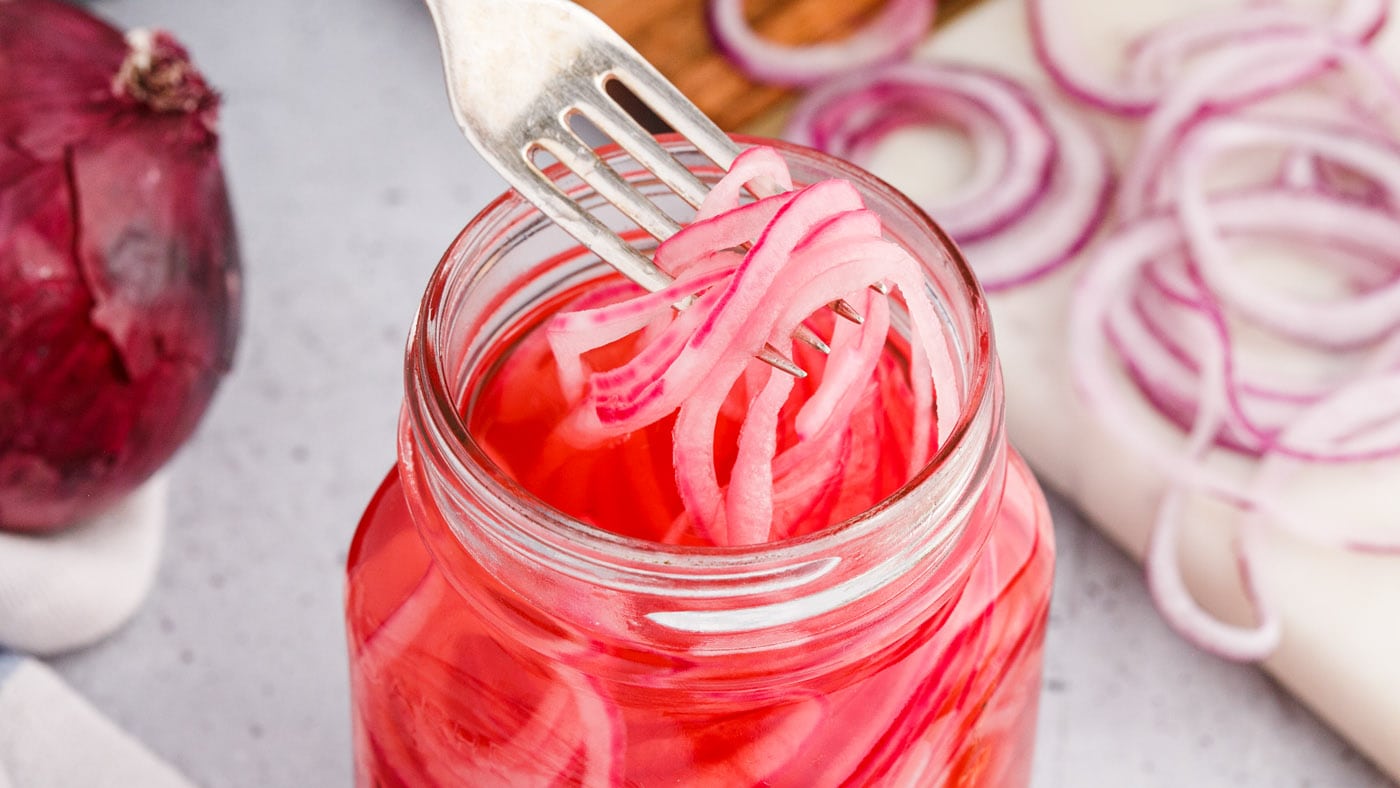 Simply slice the onion thin, add it to a mason jar, and pour the simmered vinegar mixture over the t