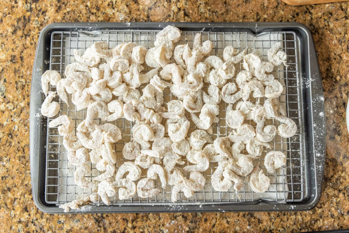 flour dredged shrimp on a wire rack 