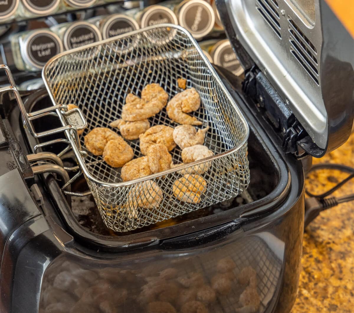 breaded shrimp in deep fryer basket