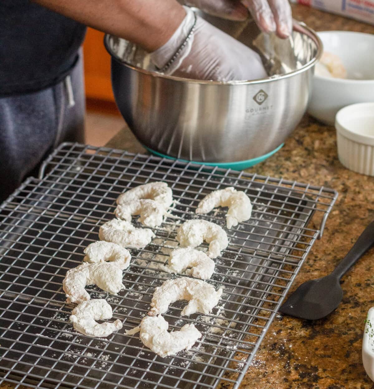 flour coated shrimp on a wire rack