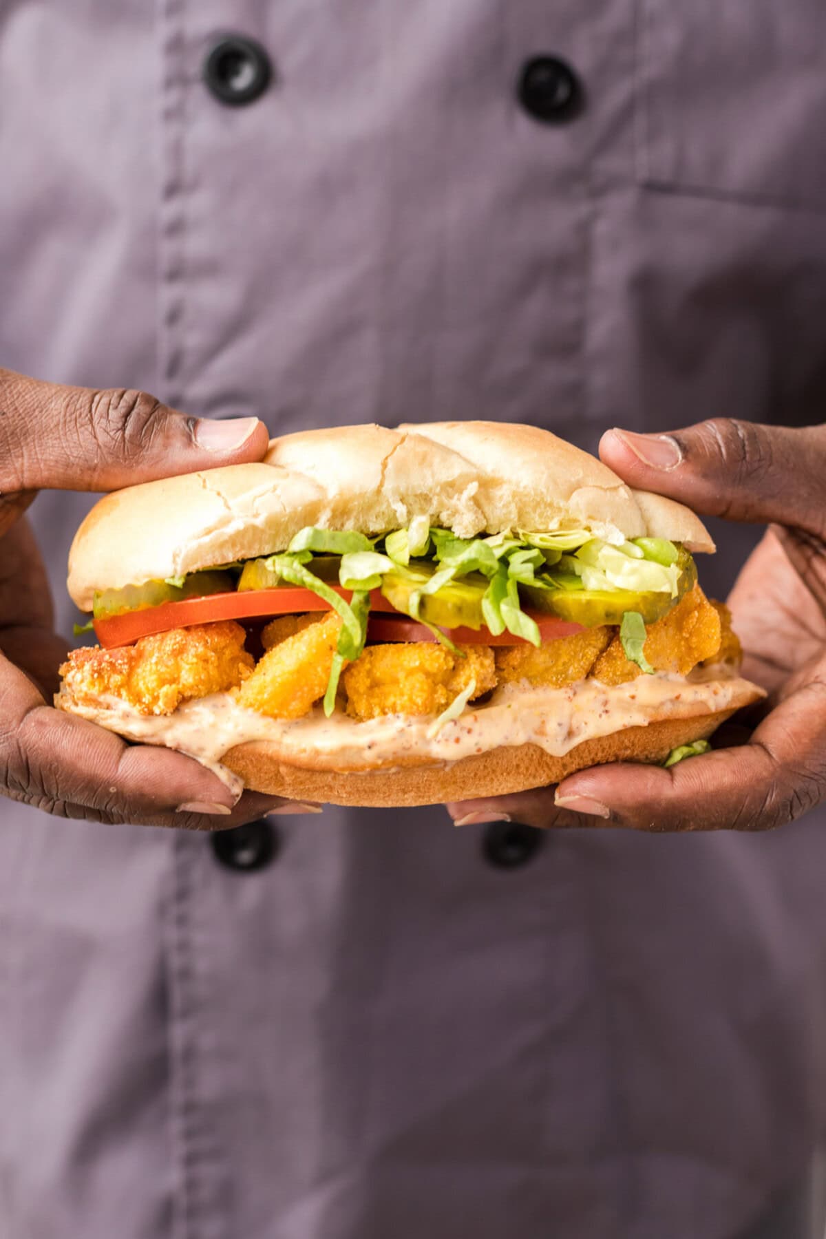 chef holding a Shrimp Po Boy