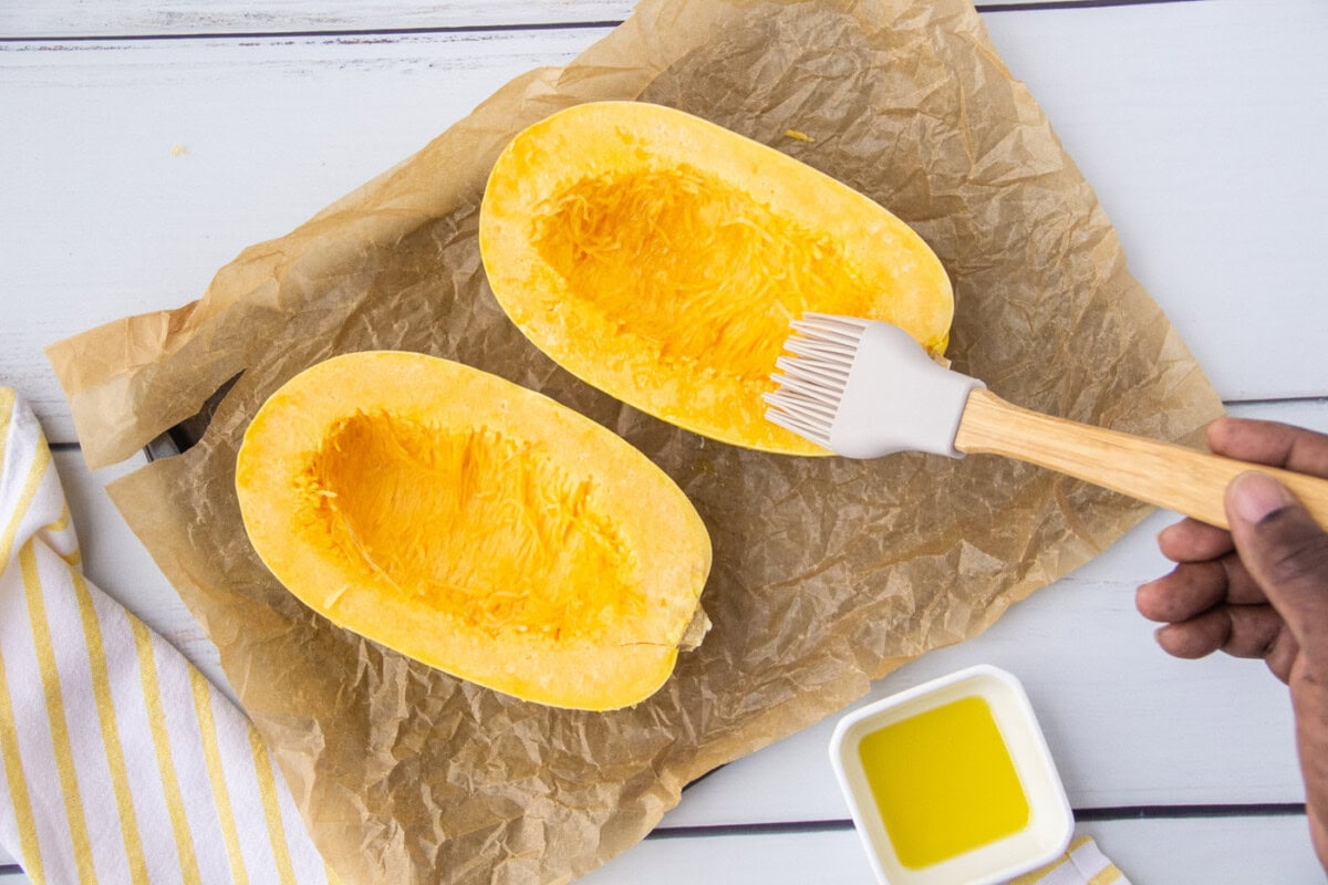 brushing olive oil on spaghetti squash