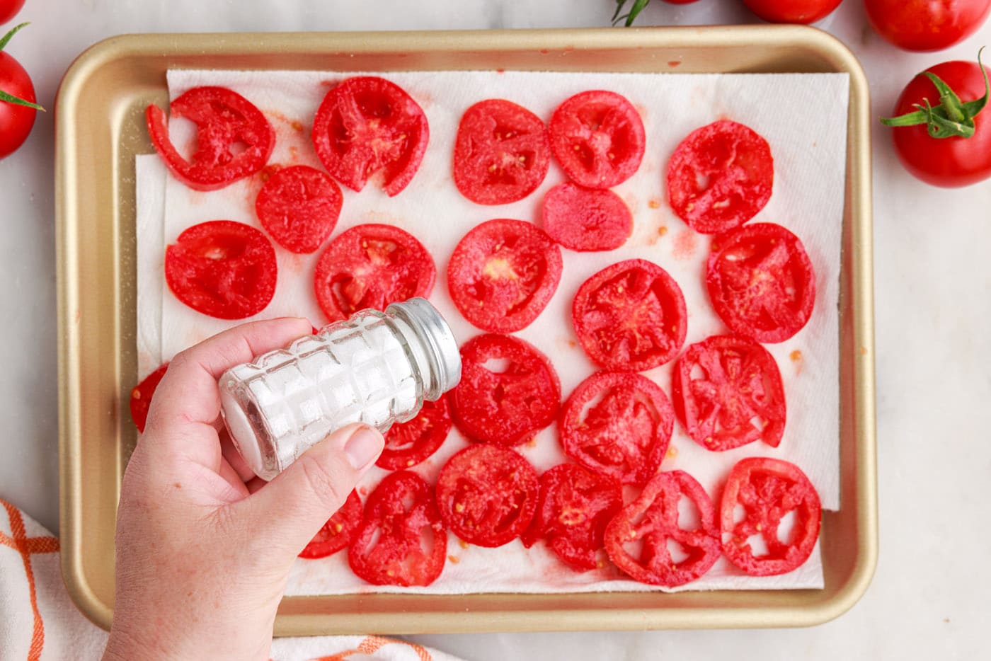 salting tomatoes on a pan