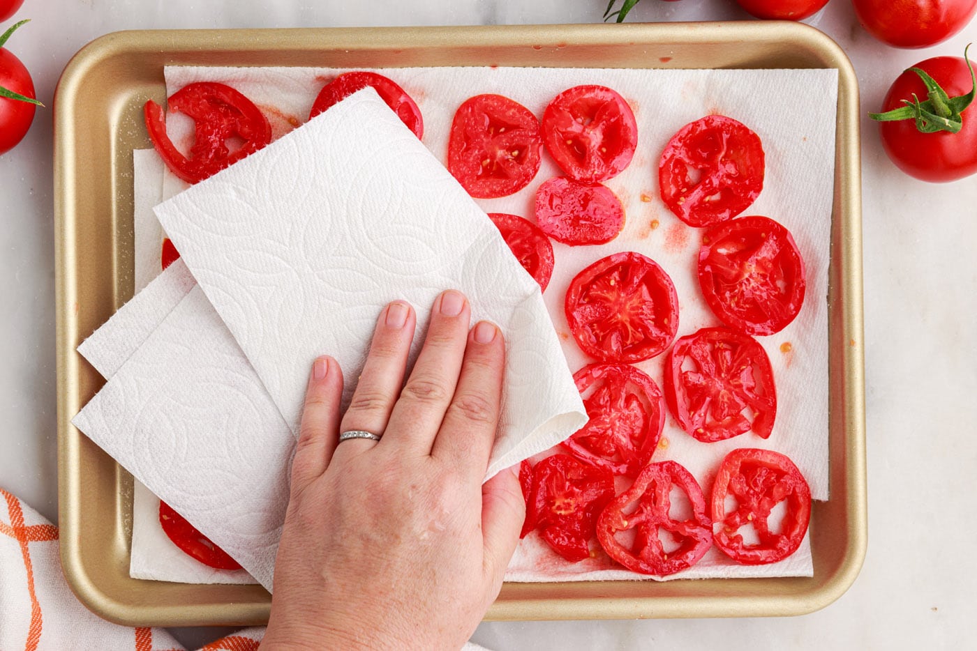 patting tomatoes dry with paper towels