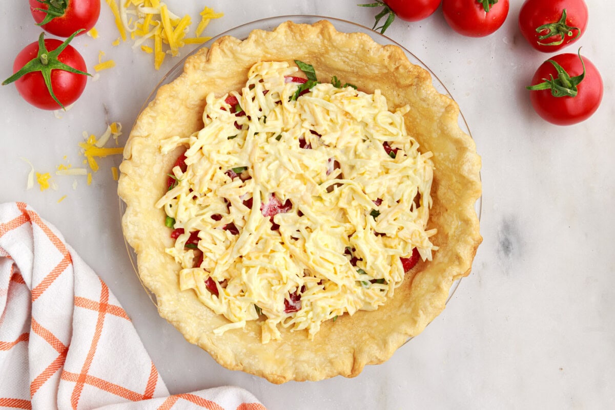 cheese on top of tomato and basil in pie