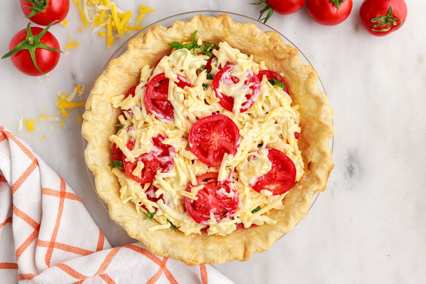 tomato, cheese, and basil layers in tomato pie