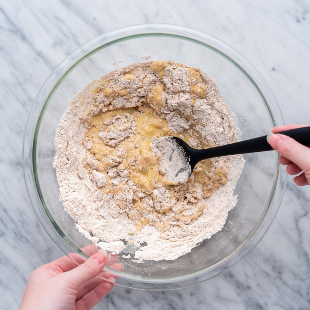 mixing apple fritter batter in a bowl with spatula
