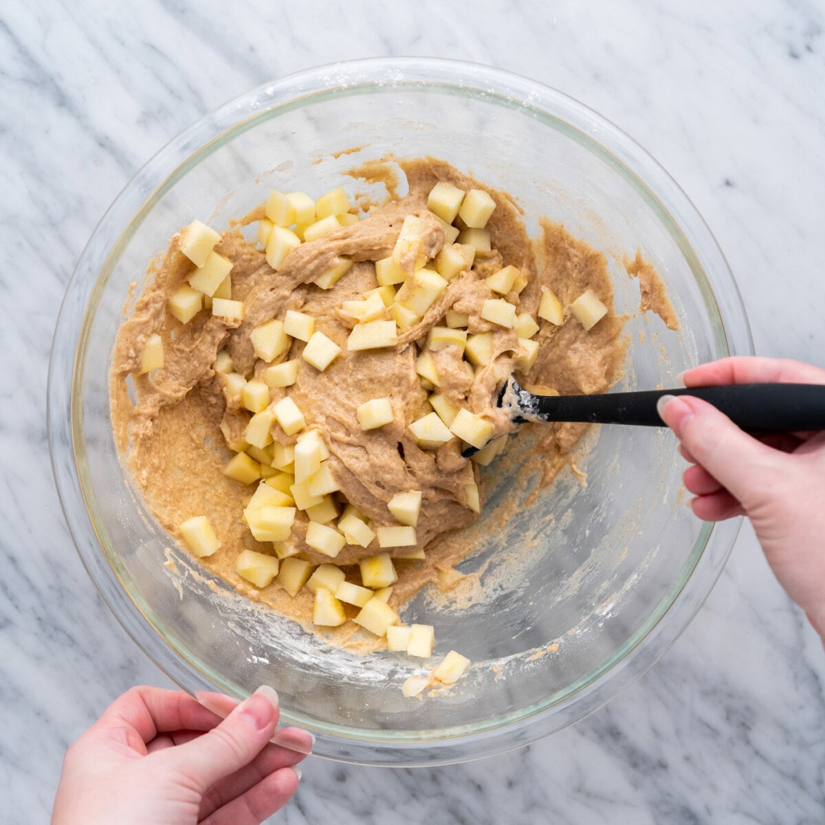 folding chopped apples into apple fritter batter