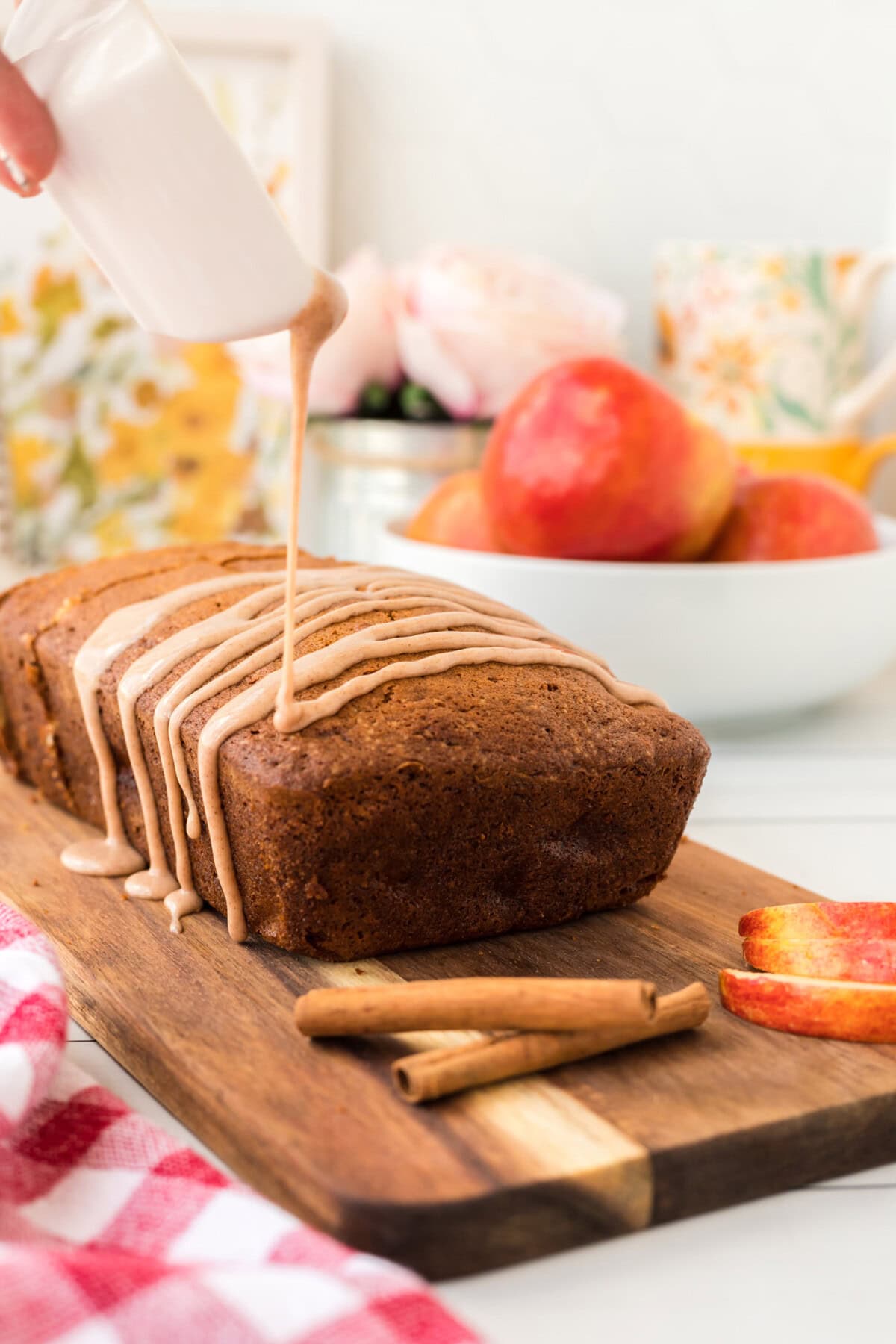 drizzling glaze on loaf of Apple Bread
