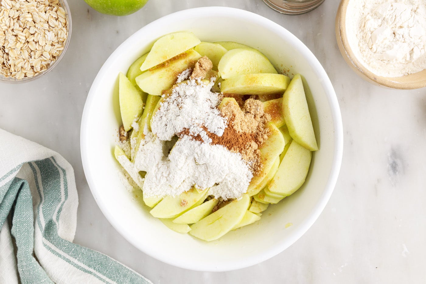 apples with brown sugar, cinnamon and flour in a bowl