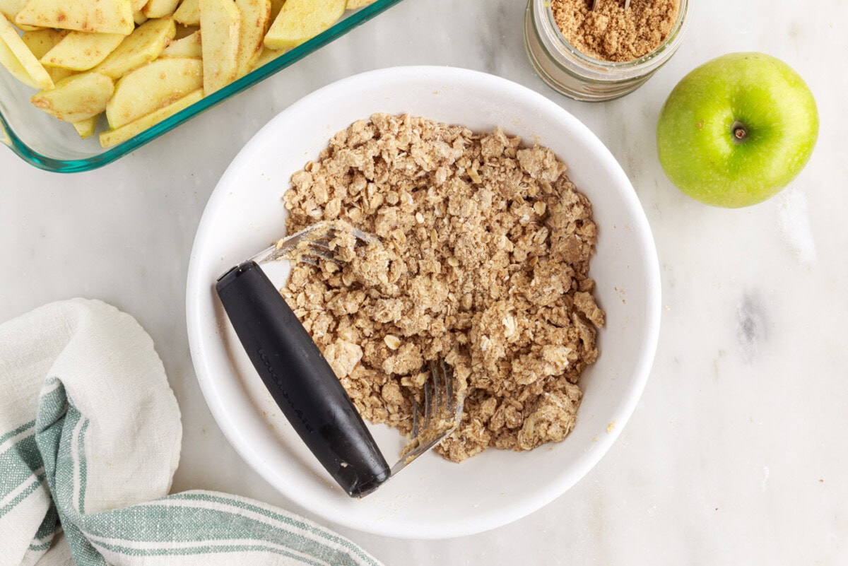 pastry cutter mixing rolled oat filling with butter