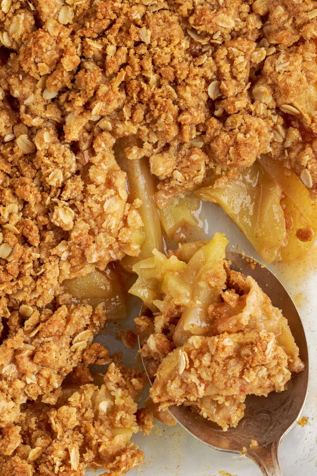 spoon in a pan of Apple Crumble