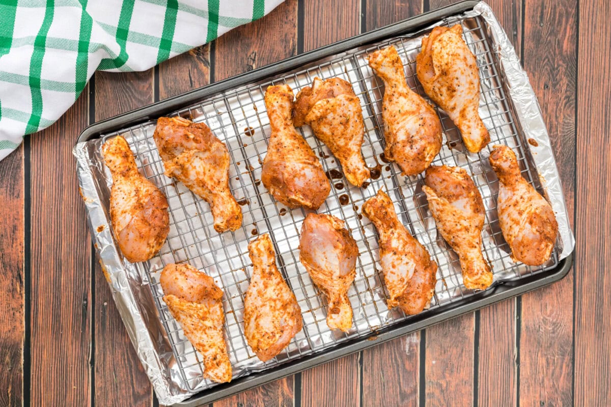 seasoned chicken legs on a wire rack