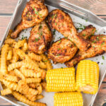 Baked Chicken Legs with fries and corn
