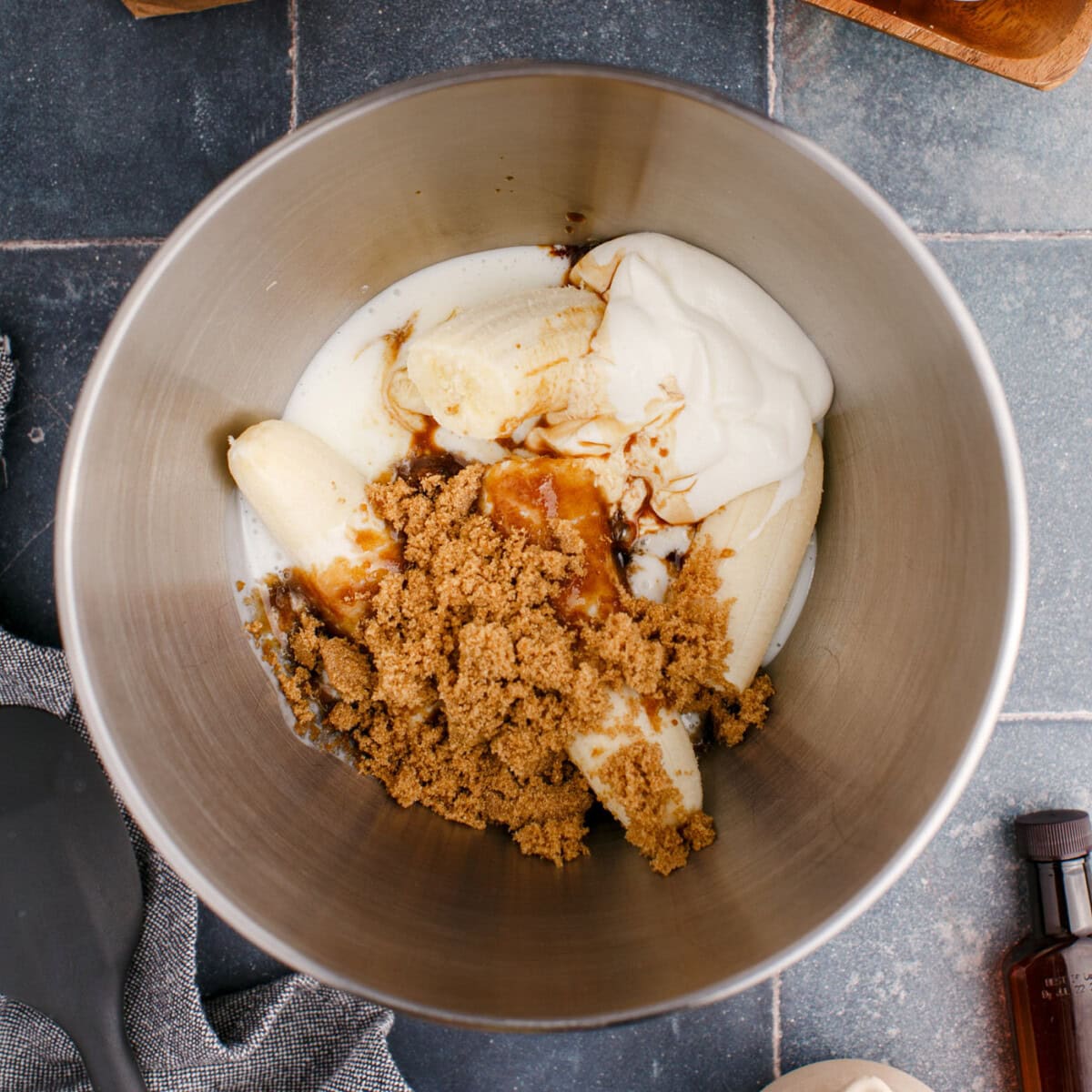 bananas, buttermilk, sour cream, and brown sugar in a bowl