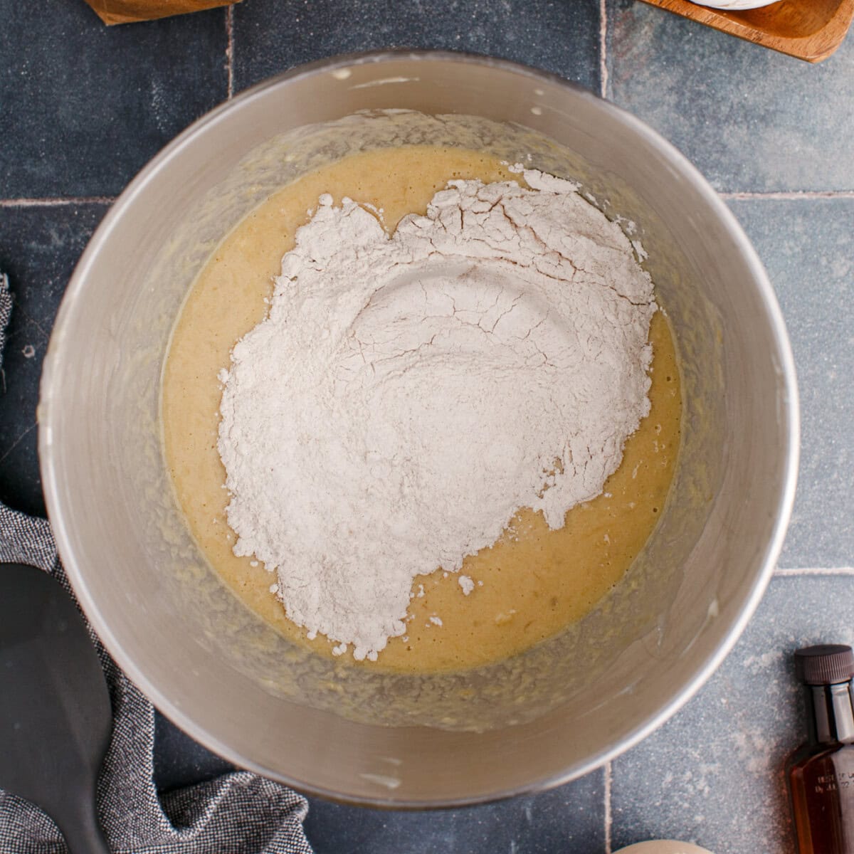 adding dry ingredients to wet ingredients for banana muffins