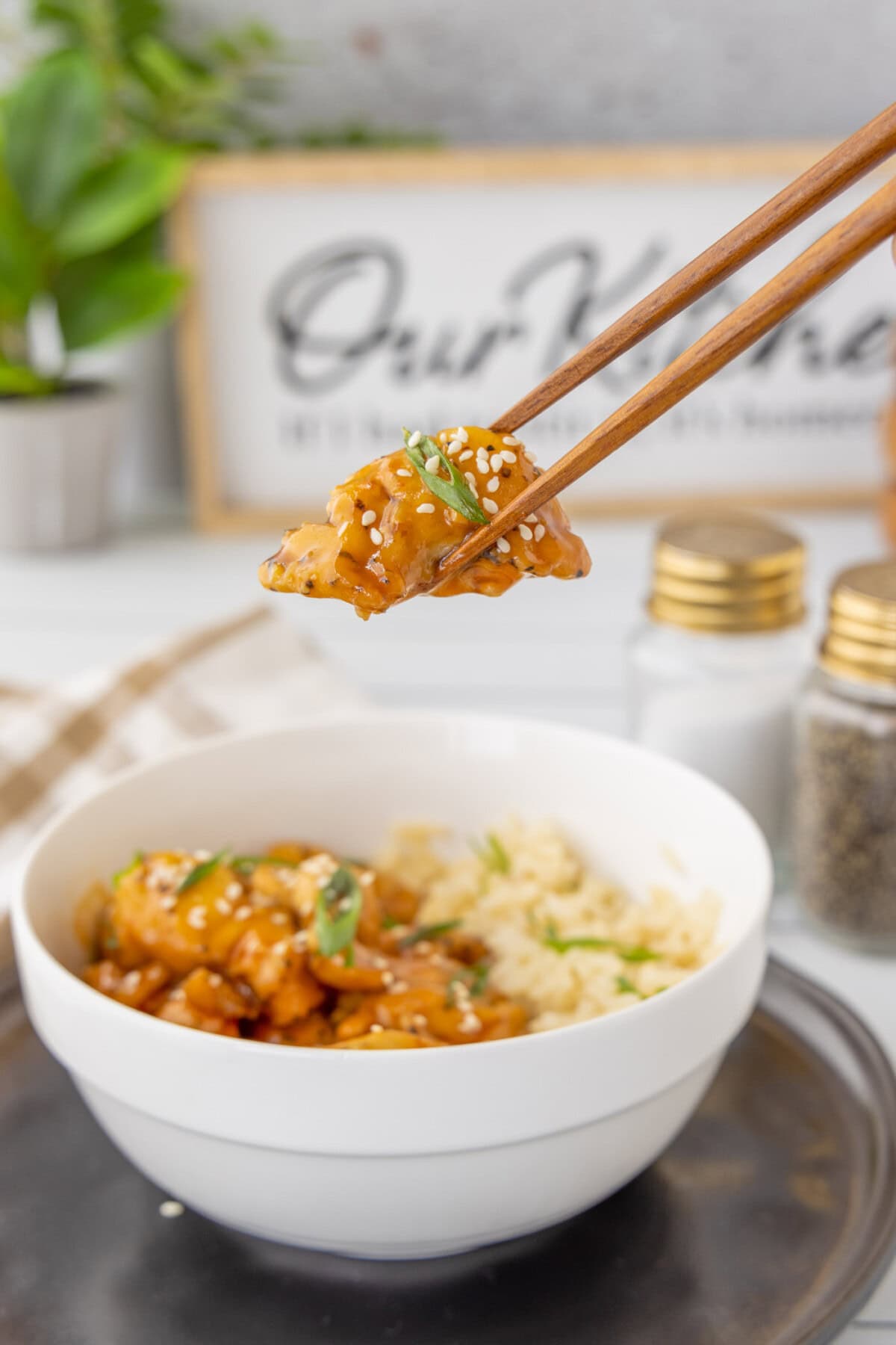 lifting Bourbon Chicken with chopsticks