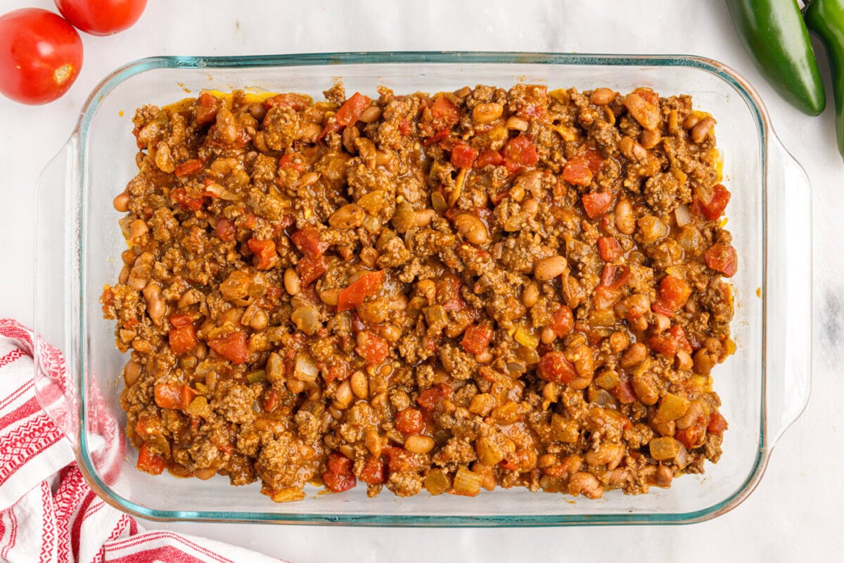 meat mixture on top of fritos and cheese in a dish