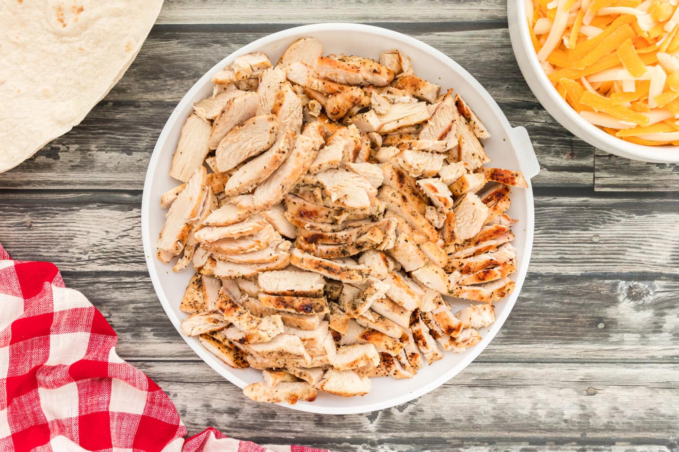sliced cooked chicken breasts in a bowl