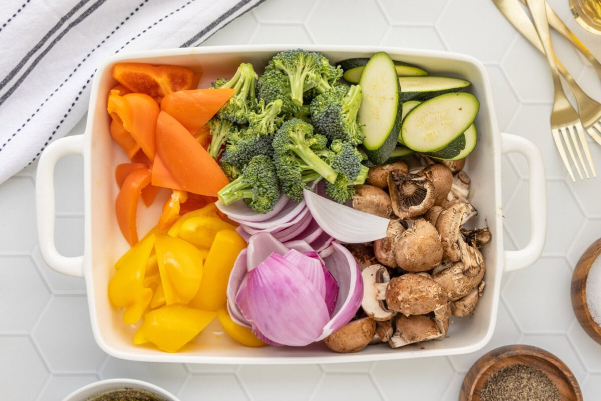 onion, bell pepper, mushrooms, zucchini, and broccoli cut in a baking dish