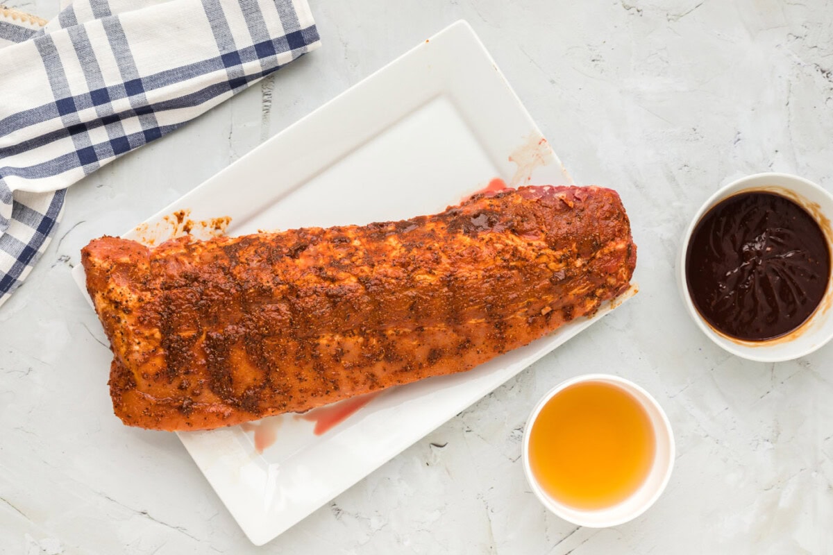 baby back ribs covered in a wet rub