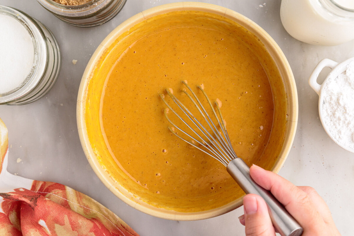 pumpkin pie filling in a bowl with a whisk