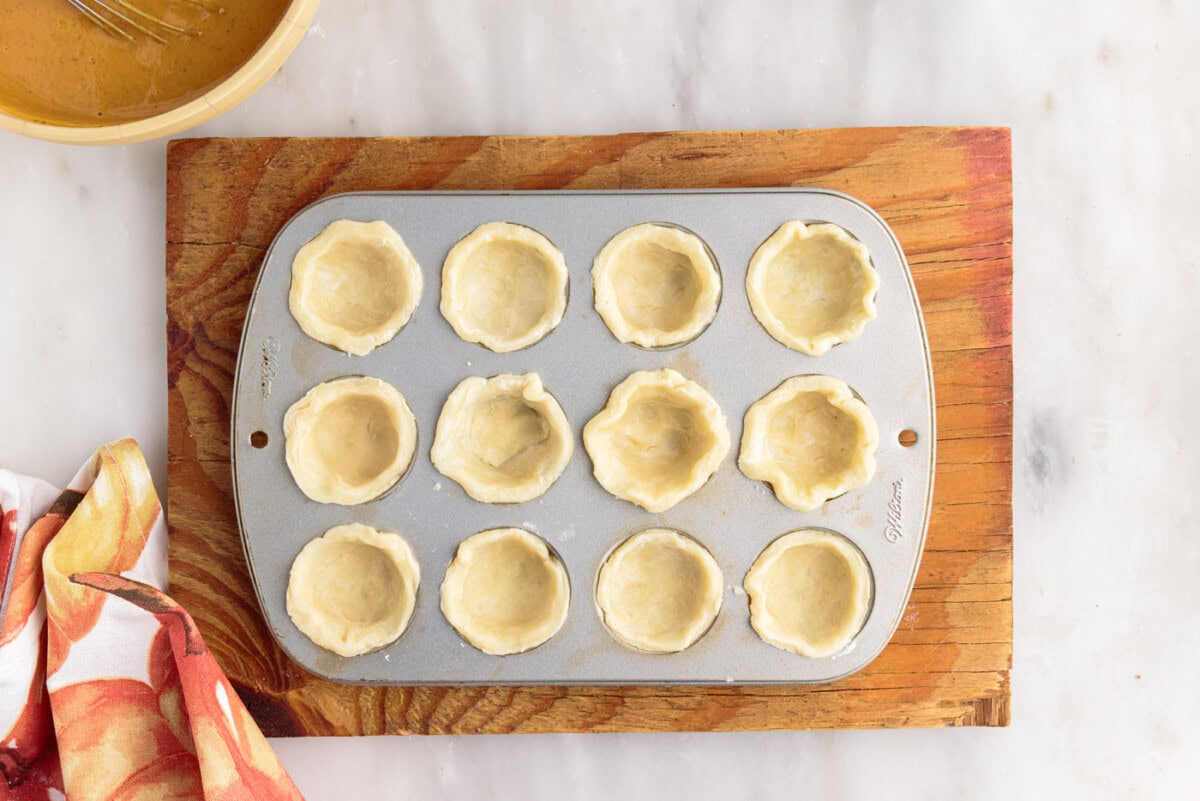mini pie dough in a muffin tin