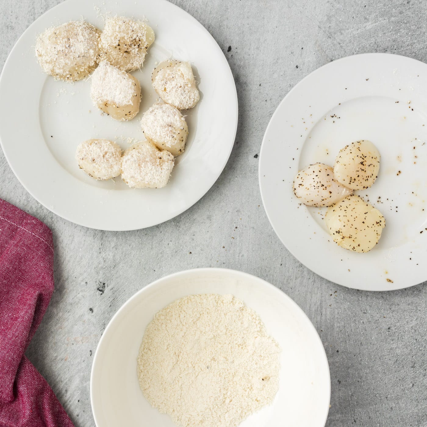 placing scallops in parmesan and flour mixture