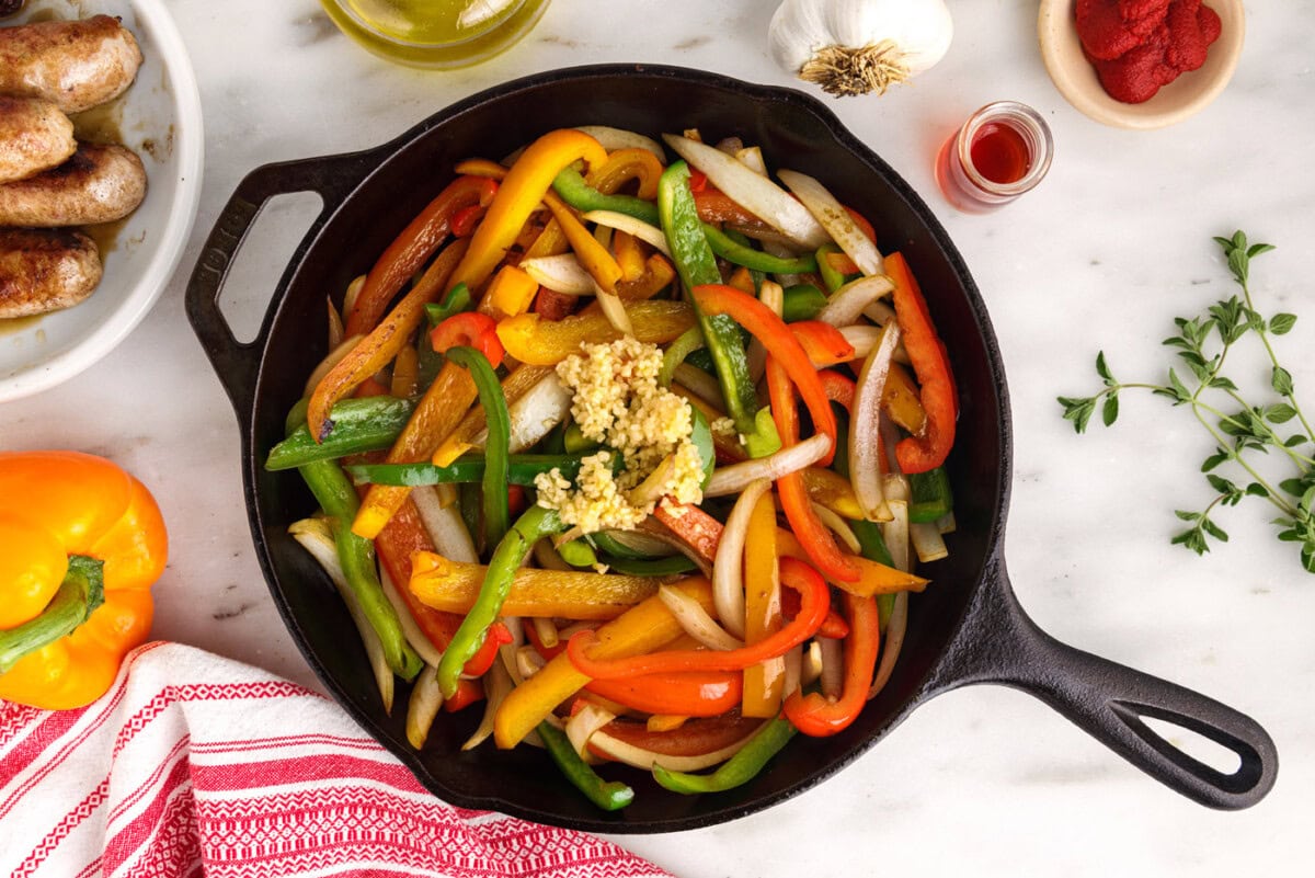 garlic, peppers, and onions in a skillet