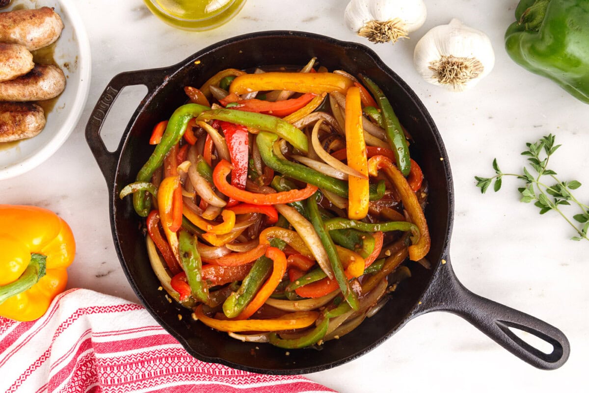peppers and onions seared in a skillet with red wine vinegar