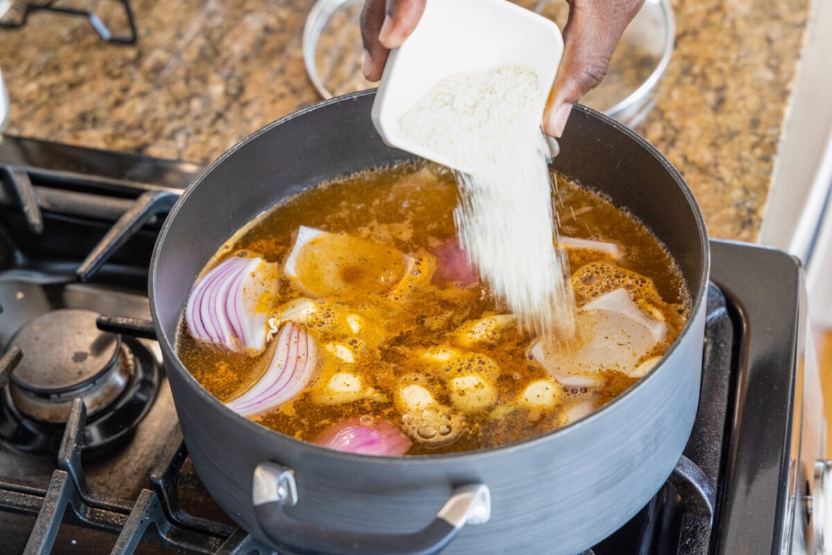 adding onions garlic and seasonings to large stockpot