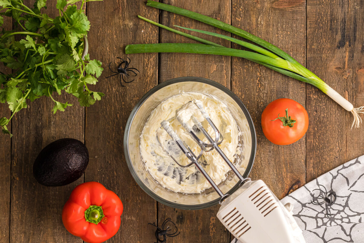 beating cream cheese with a hand mixer
