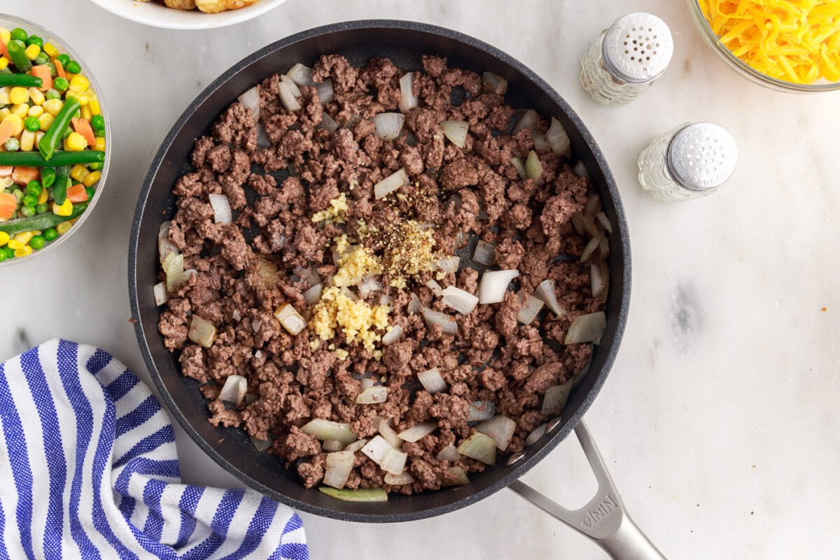 tatertot casserole beef and garlic in a skillet