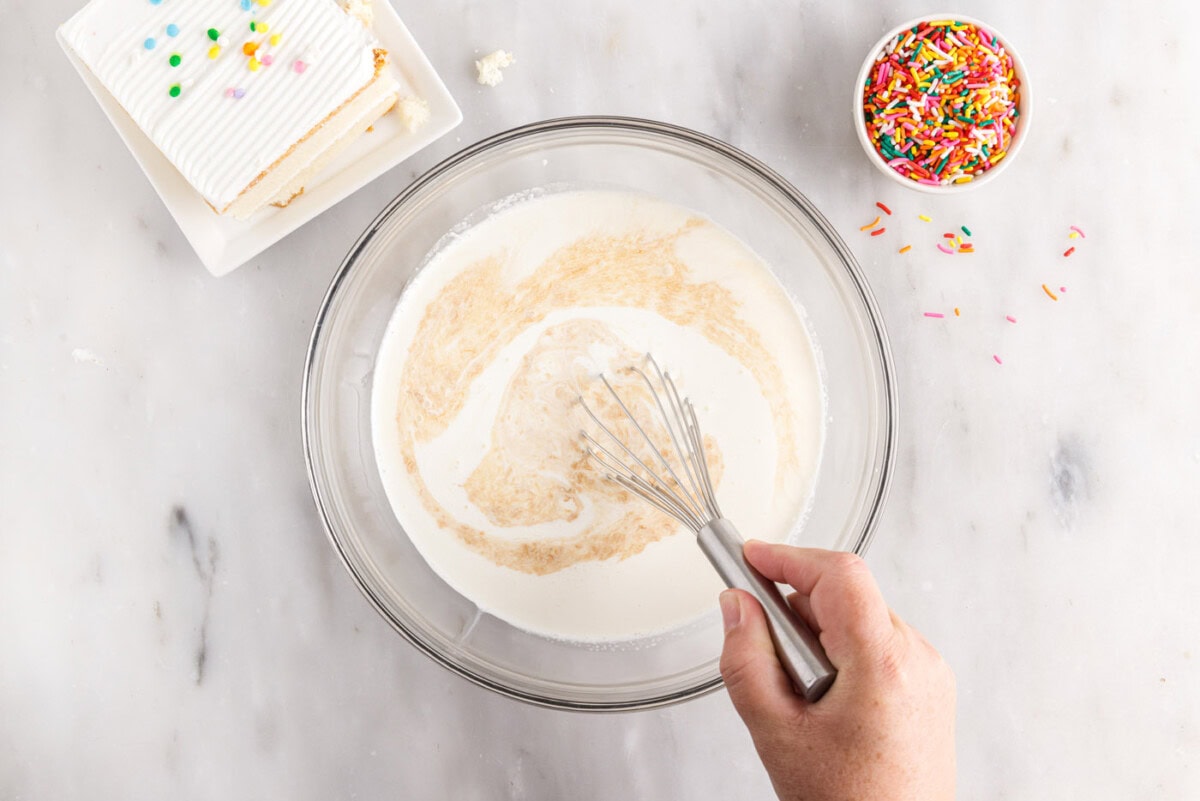whisking sweetened condensed milk, heavy cream, salt and vanilla in a bowl