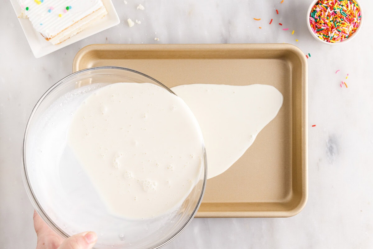 pouring ice cream mixture into a sheet pan